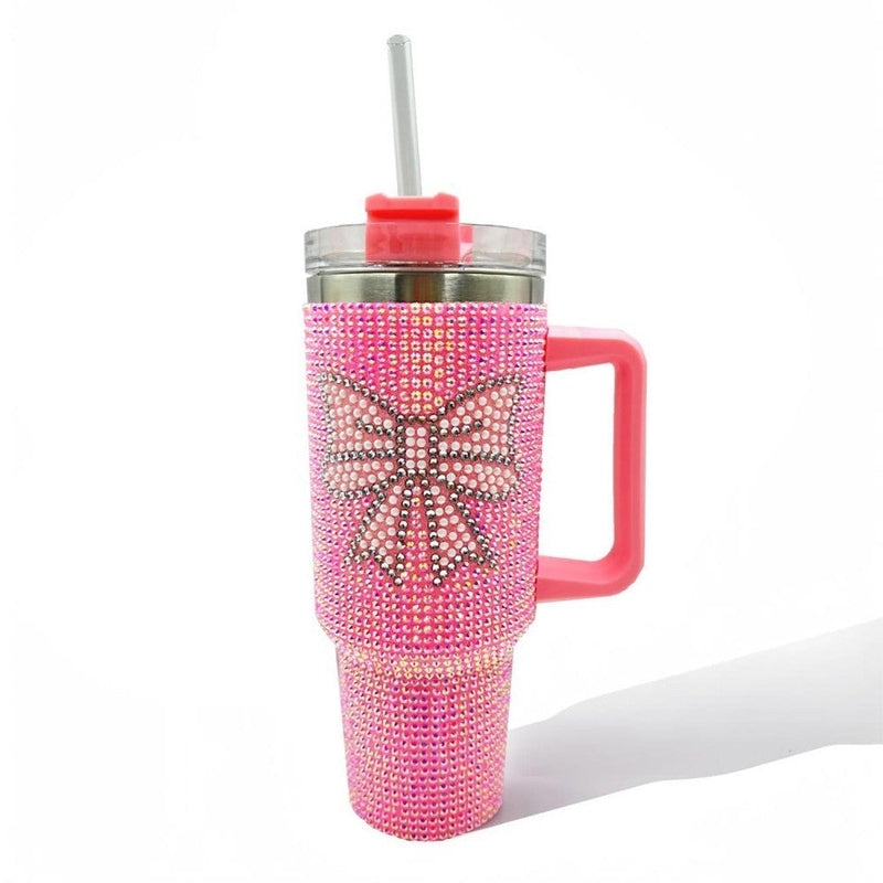 Rhinestone-covered tumbler with decorative bow detail on the lid