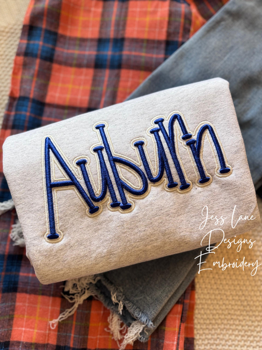 ash gray sweatshirt with auburn puff embroidery in blue and cream thread