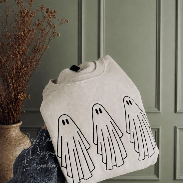 embroidered ghost Halloween sweatshirt on a Gildan sand sweatshirt with black thread