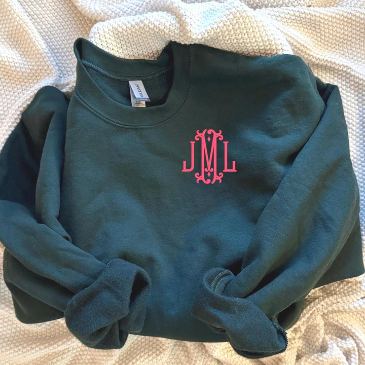 forest green Gildan crewneck with bright pink embroidered monogram on the left chest, personalized monogram sweatshirt for women.